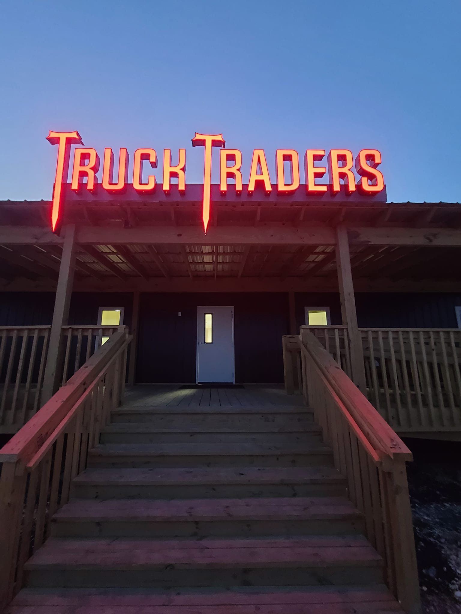 Truck Traders glowing sign at dusk